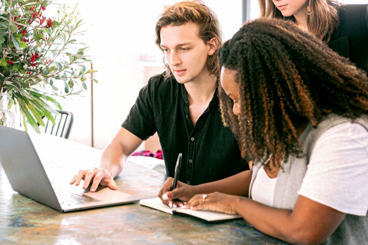 Man Using A Laptop Explaining To A Lady