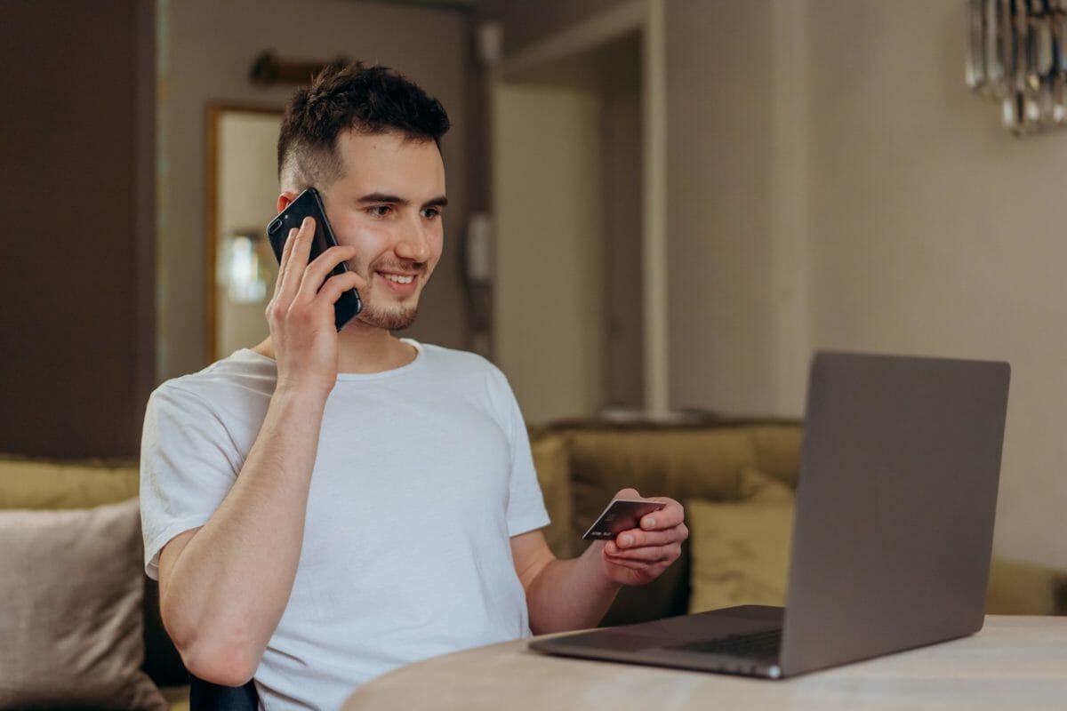 Guy Holding Phone And Credit Card