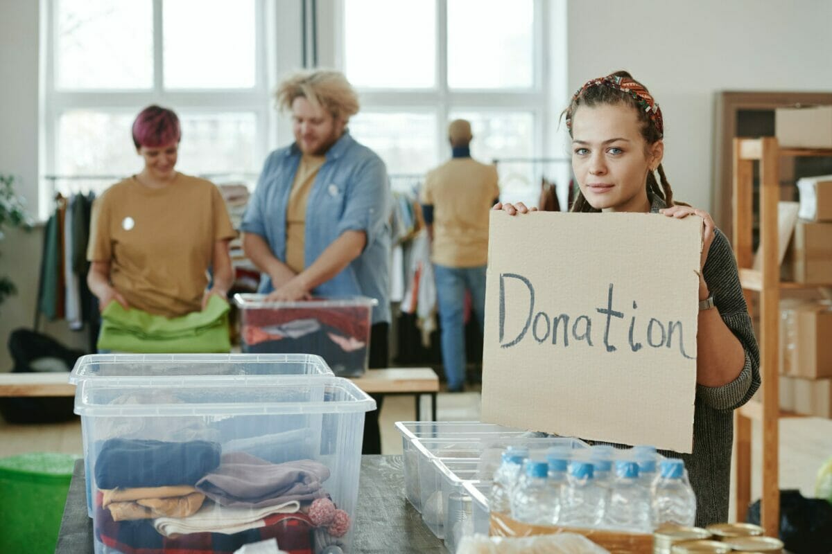 A Woman Holding A Cardboard With Inscription
